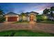 Charming single-Gathering home featuring a brick driveway, attached garage, and a well-manicured lawn at 132 Giralda Ne Blvd, St Petersburg, FL 33704