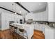 Modern kitchen with white cabinets, stainless steel appliances, and pendant lighting at 132 Giralda Ne Blvd, St Petersburg, FL 33704