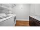 Well-equipped laundry room with modern appliances and wood flooring at 132 Giralda Ne Blvd, St Petersburg, FL 33704