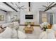 Bright living room with decorative fans, a white brick accent wall, and cozy seating arrangements at 132 Giralda Ne Blvd, St Petersburg, FL 33704