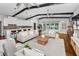 Bright living room with hardwood floors, beamed ceilings, access to backyard, and an eat-in kitchen at 132 Giralda Ne Blvd, St Petersburg, FL 33704
