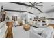 Bright and open living room flows into a kitchen, featuring seating and wood beams at 132 Giralda Ne Blvd, St Petersburg, FL 33704