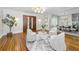 Open-concept living space featuring hardwood floors, dining area and inviting sitting area with modern decor at 132 Giralda Ne Blvd, St Petersburg, FL 33704