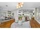 Open-concept living space with hardwood floors, modern lighting, dining area, and an inviting sitting area at 132 Giralda Ne Blvd, St Petersburg, FL 33704