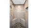 Stylish shower with pebble floor, integrated seating, and unique tile accents at 132 Giralda Ne Blvd, St Petersburg, FL 33704