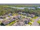 Aerial view showcases a community near a lake surrounded by lush trees and beautiful modern homes at 13859 Sharp Hawk Dr, Riverview, FL 33569