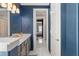 Luxury bathroom with gold fixtures, dual sinks, marble floors, and a doorway leading to another room at 13859 Sharp Hawk Dr, Riverview, FL 33569