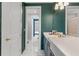 Elegant bathroom featuring a dark green wall, white marble floors and countertops, and gold hardware at 13859 Sharp Hawk Dr, Riverview, FL 33569