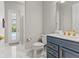 Modern bathroom with double vanity, marble floors and a walk-in shower at 13859 Sharp Hawk Dr, Riverview, FL 33569