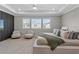 Bright primary bedroom with large bed, lounge chairs, and natural light from big windows at 13859 Sharp Hawk Dr, Riverview, FL 33569