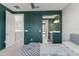 Stylish bedroom with en-suite bathroom, featuring a unique color scheme and views into other living spaces at 13859 Sharp Hawk Dr, Riverview, FL 33569