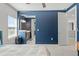 View of an open bedroom with a blue accent wall that has entrances to a bathroom and hallway at 13859 Sharp Hawk Dr, Riverview, FL 33569
