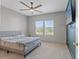 Bedroom featuring a ceiling fan, a tv, and a window with a view to the outside at 13859 Sharp Hawk Dr, Riverview, FL 33569