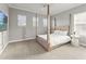 A stylish bedroom boasts a four-post bed, soft lighting, and neutral walls that provide a relaxing space at 13859 Sharp Hawk Dr, Riverview, FL 33569