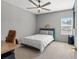 Cozy bedroom with a queen bed, desk, ceiling fan, and neutral-toned walls with crown molding at 13859 Sharp Hawk Dr, Riverview, FL 33569