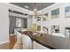 Elegant dining room with a wooden table, modern light fixture, and stylish decor for sophisticated dinners at 13859 Sharp Hawk Dr, Riverview, FL 33569