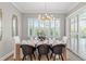 Dining room boasts stylish chairs, plantation shutters and modern lighting fixture at 13859 Sharp Hawk Dr, Riverview, FL 33569