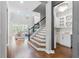 Inviting entryway with staircase and a butler's pantry, seamlessly blending functionality with modern home design at 13859 Sharp Hawk Dr, Riverview, FL 33569