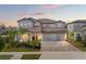 Beautiful two-story home with a three-car garage, complemented by lush landscaping and a spacious driveway at 13859 Sharp Hawk Dr, Riverview, FL 33569