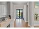 Elegant foyer with hardwood floors, stylish decor, and a clear view of the front door at 13859 Sharp Hawk Dr, Riverview, FL 33569