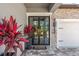 Stylish front entrance featuring a modern double door, brick accents, and vibrant plants at 13859 Sharp Hawk Dr, Riverview, FL 33569