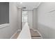 Hallway features elegant trim, leading to a room with a chandelier, enhancing its appeal at 13859 Sharp Hawk Dr, Riverview, FL 33569