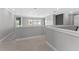 Bright and airy hallway with neutral tones, showcasing pristine trim work and views to other rooms at 13859 Sharp Hawk Dr, Riverview, FL 33569