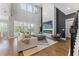Spacious living room with soaring ceilings, statement fireplace, and modern finishes; perfect for entertaining and relaxation at 13859 Sharp Hawk Dr, Riverview, FL 33569