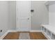 Mud room features a door, built-in bench, and hardwood floors with accent rug at 13859 Sharp Hawk Dr, Riverview, FL 33569