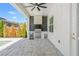 Outdoor kitchen with stone backsplash, stainless steel grill, and beverage center on a stone patio at 13859 Sharp Hawk Dr, Riverview, FL 33569