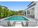 A serene backyard oasis with a sparkling pool and sun loungers, perfect for relaxing outdoor living at 13859 Sharp Hawk Dr, Riverview, FL 33569
