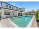 Backyard swimming pool with a stone deck, covered patio, and a view of the home's exterior at 13859 Sharp Hawk Dr, Riverview, FL 33569