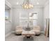 Cozy sitting area features a stylish geometric chandelier and neutral decor that complements the room's serene ambiance at 13859 Sharp Hawk Dr, Riverview, FL 33569
