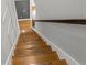 Hardwood staircase with white risers and a dark wooden handrail, creating an inviting entrance at 13859 Sharp Hawk Dr, Riverview, FL 33569