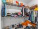 Spacious walk-in closet filled with clothing, shoes and bags on shelving, providing ample storage and organization at 13859 Sharp Hawk Dr, Riverview, FL 33569