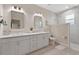 Bright bathroom featuring double vanity with undermount sinks, framed mirrors, and a separate shower space at 14024 Wenzel Ave, Port Charlotte, FL 33981