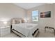 Cozy bedroom features a comfortable bed, side table, and an abundance of natural light at 14024 Wenzel Ave, Port Charlotte, FL 33981
