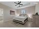 Bright bedroom with a ceiling fan, neutral walls, and stylish decor creating a cozy, relaxing space at 14024 Wenzel Ave, Port Charlotte, FL 33981