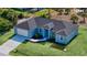 New construction home featuring a two car garage, landscaped yard, and a covered entryway at 14024 Wenzel Ave, Port Charlotte, FL 33981