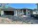 Home construction with an unfinished exterior, garage, and debris in the front yard at 14024 Wenzel Ave, Port Charlotte, FL 33981