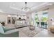 Open concept living room and kitchen featuring modern finishes, recessed lighting, and patio access at 14024 Wenzel Ave, Port Charlotte, FL 33981