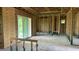 Unfinished living room with large glass doors, exposed wall studs, and a concrete floor at 14024 Wenzel Ave, Port Charlotte, FL 33981