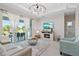 Bright living room showcasing the modern light fixture, patio access, and comfortable seating at 14024 Wenzel Ave, Port Charlotte, FL 33981