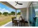 Covered patio featuring a dining table and chairs overlooking a grassy backyard and trees at 14024 Wenzel Ave, Port Charlotte, FL 33981