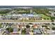 Aerial view of homes near a school with playground, sports field, and a large parking area at 14027 Bensbrook Dr, Spring Hill, FL 34609