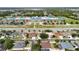 Aerial view of homes near a school with playground, sports field, and a large parking area at 14027 Bensbrook Dr, Spring Hill, FL 34609