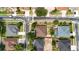 An aerial view depicts the layout of a neighborhood, showcasing fenced yards and mature trees at 14027 Bensbrook Dr, Spring Hill, FL 34609