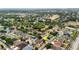 A neighborhood aerial shot with houses, green spaces and an arrow indicating a property, showcasing suburban living at 14027 Bensbrook Dr, Spring Hill, FL 34609