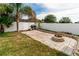 Spacious backyard features a brick patio with a built-in fire pit and grill area, perfect for outdoor entertaining at 14027 Bensbrook Dr, Spring Hill, FL 34609