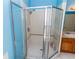 Bathroom featuring a glass shower with a shower head, white tile walls, and a marble base at 14027 Bensbrook Dr, Spring Hill, FL 34609